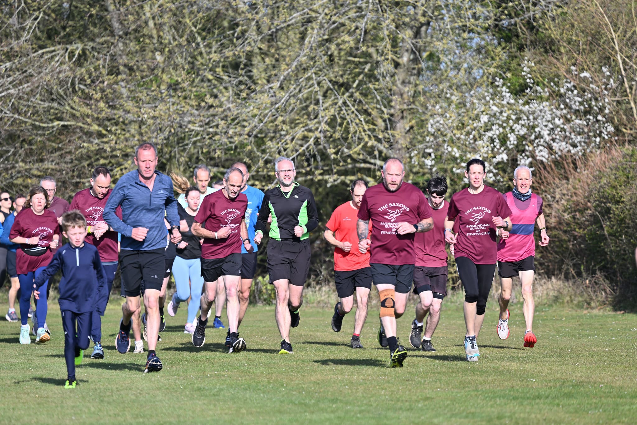 Group of runners racing in a field