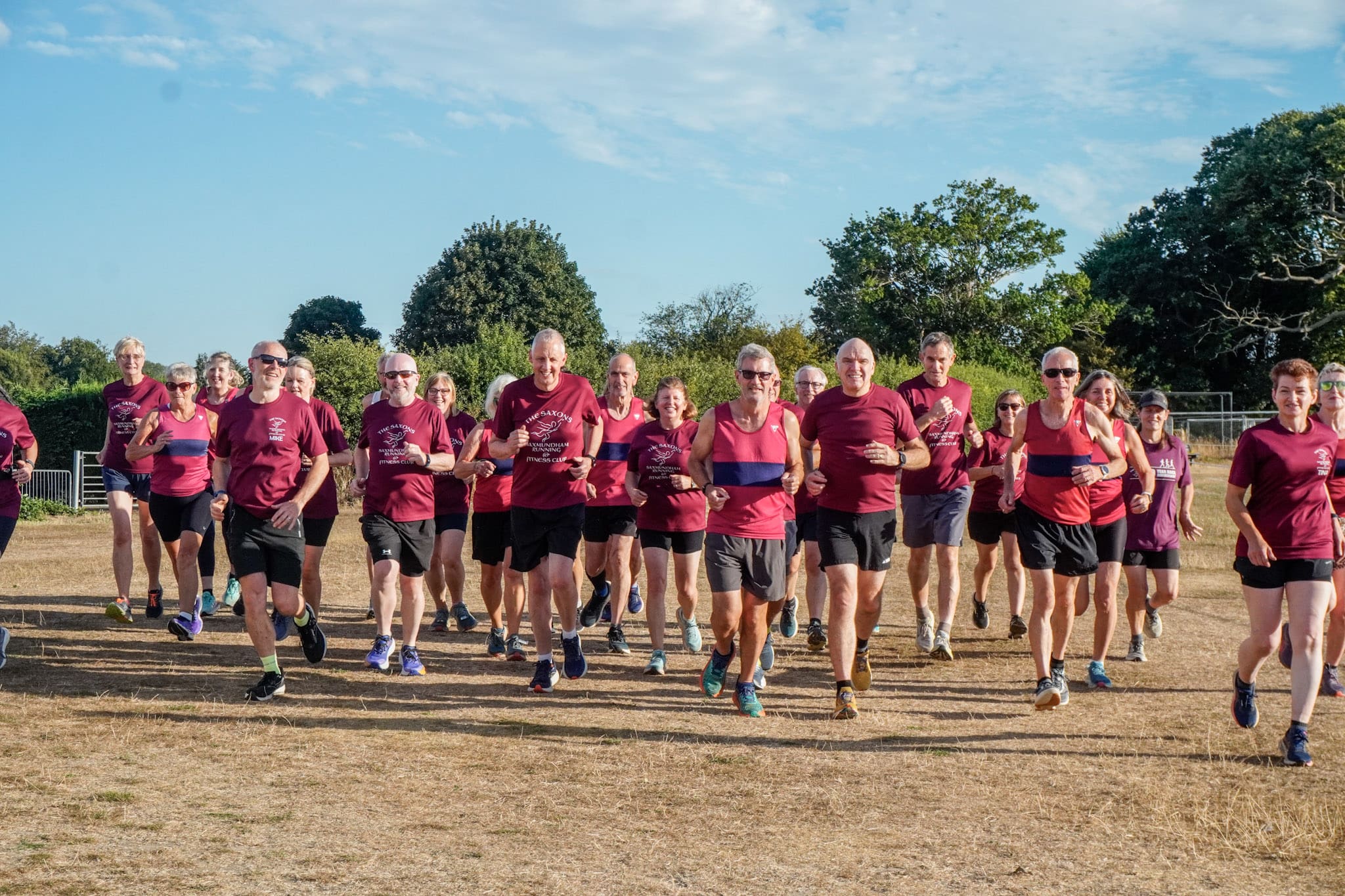 Group of runners aged over 50 years of age running on a field